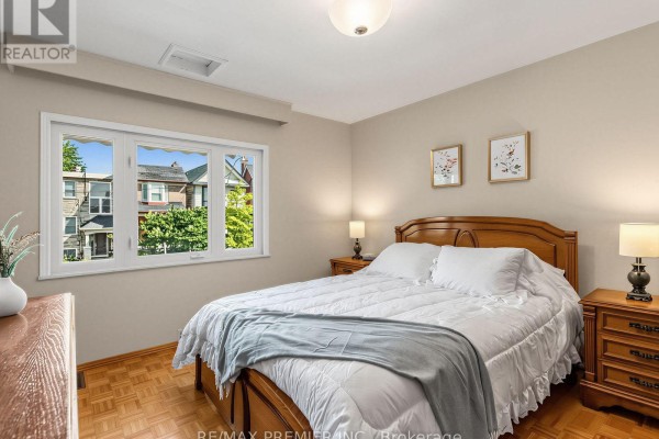 Wooden bed with white linens and grey throw - 155 Ascot Avenue Toronto