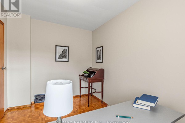 Office with wooden desk, framed photos, and parquet flooring - 155 Ascot Avenue Toronto