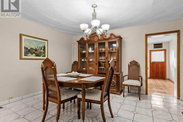 Wooden china cabinet, dining table, and chairs in a formal dining room - 155 Ascot Avenue Toronto