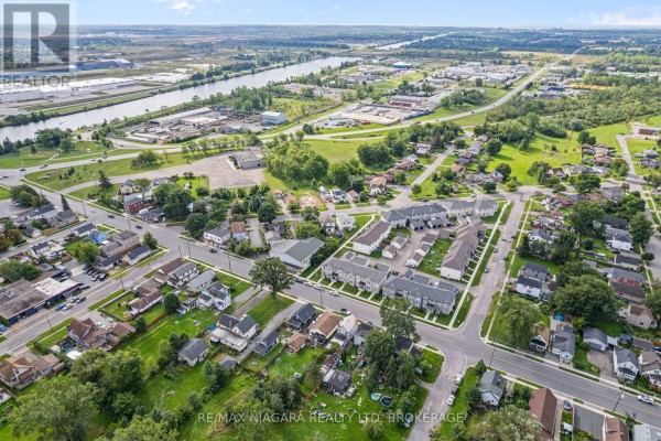 Aerial view of residential homes and townhouses near a river - 155 Broadway Street Welland