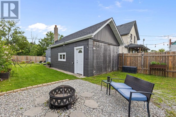 Backyard with fire pit, outdoor seating, hammock, and garage - 155 Broadway Street Welland