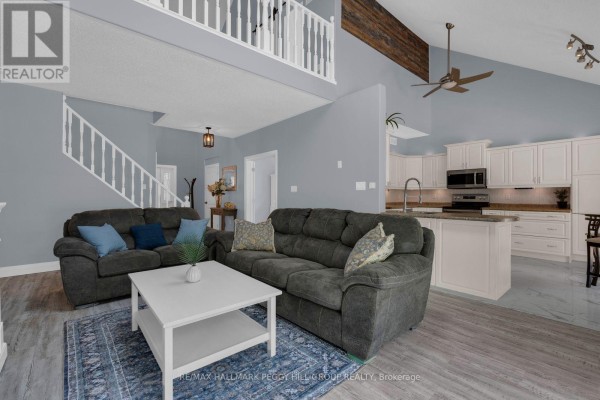 Spacious living room with a sectional sofa, coffee table, and an open view to the kitchen and loft. - 155 Forest Glen Drive, Gravenhurst)