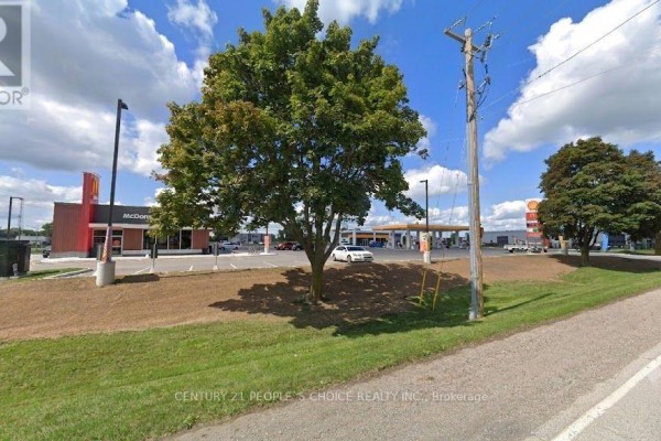 McDonald's restaurant with drive-thru lane and adjacent Shell gas station visible. - 155 Junction Avenue, Chatham Kent