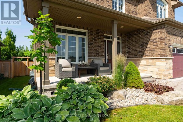 Covered front porch with wicker seating and landscaping. - 155 Spencer Avenue, Lucan Biddulph