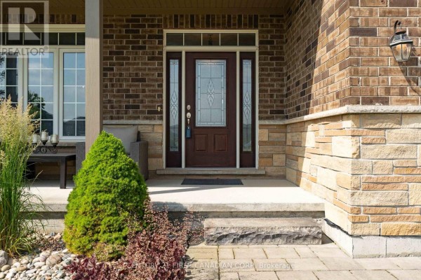 Close-up of the front entrance with a dark wood door and sidelight windows. - 155 Spencer Avenue, Lucan Biddulph