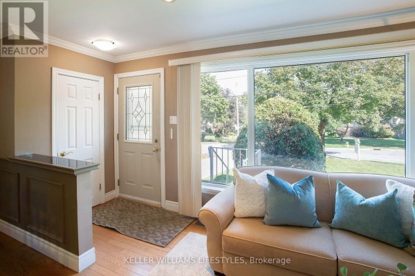 Interior entryway with a beige sofa, large picture window, and light brown walls. - 155 Trowbridge Avenue, London South