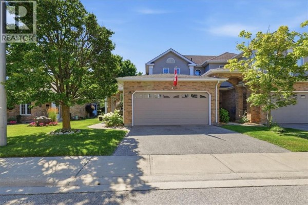 Close-up exterior view of a brick townhouse entrance with a covered porch. - 1550 Gordon Street Unit# 18, Guelph