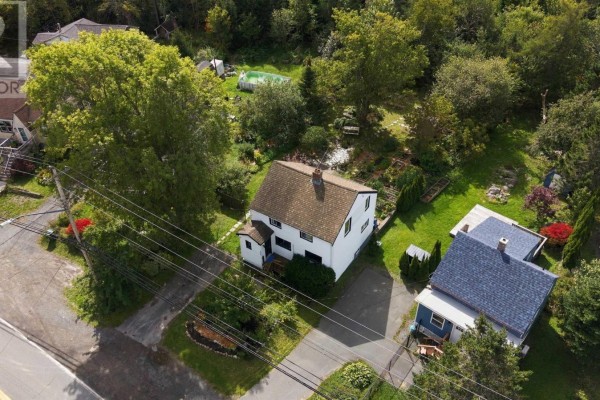 Aerial view of the property showing the house, surrounding gardens, and neighboring structures. - 1556 St Margarets Bay Road, Lakeside