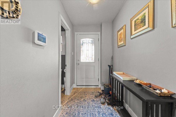 Interior entryway with light gray walls, wood floor, and console table. - 156 Birch Hill Private N, Ottawa