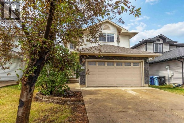 View of the house from the left, showing trees and the front entrance. - 156 J.w. Mann Drive, Fort Mcmurray
