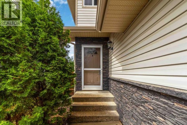 Close-up of the front door entrance with steps and stone accents on the exterior. - 156 J.w. Mann Drive, Fort Mcmurray