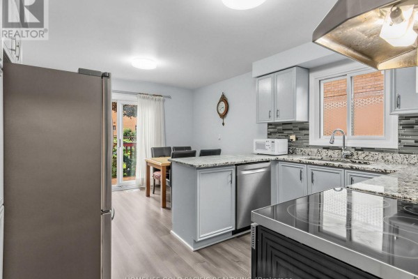 Kitchen with stainless steel appliances, granite counters, and dining area - 156 Ravenscroft Road Ajax