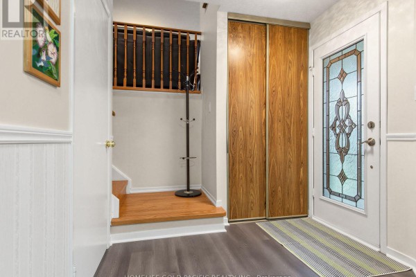 Interior entryway with a closet, stairs, coat rack, and a stained-glass front door. - 156 Ravenscroft Road, Ajax