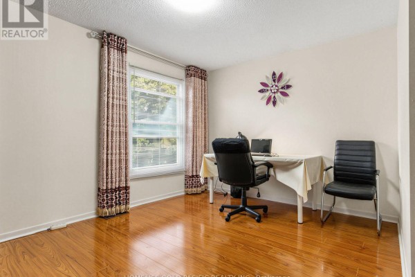 Office with desk, chairs, laptop, and window - 156 Ravenscroft Road Ajax