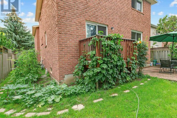 Backyard with deck, patio, umbrella and seating - 156 Ravenscroft Road Ajax
