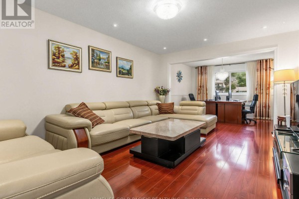 Living room with a large sectional sofa, marble-topped coffee table, and wood floors. - 156 Ravenscroft Road, Ajax