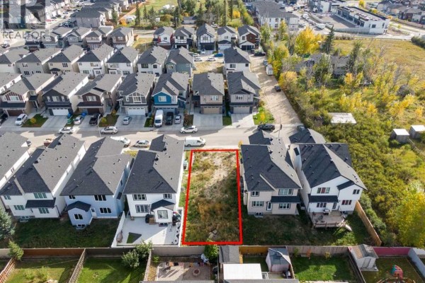 Overhead drone shot of an empty building lot on Saddlecrest Circle Ne, Calgary, with surrounding houses. - 157 Saddlecrest Circle Ne, Calgary