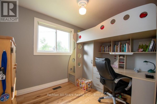 Loft bed with desk and chair in a bedroom - 1571 Elm Tree Road Kawartha Lakes