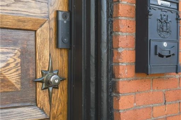 Close-up of a wooden front door with a smart doorbell and a black mailbox. - 158 Hunter Street E, Hamilton