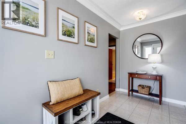 Entryway with grey walls, tiled floor, wooden bench with shoe storage, and a console table. - 1582 County Rd 34, Ruthven
