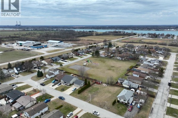Aerial view of a residential neighborhood with houses, streets, and a park with a playground and sports field. - 1583 Councillors Street, Moore Township