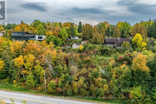 Aerial view of houses on a hill covered in autumn foliage. - 1587 Lilac Lane, Ottawa