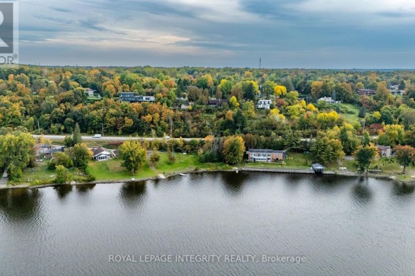 Aerial view of houses along a river shoreline with autumn trees. - 1587 Lilac Lane, Ottawa