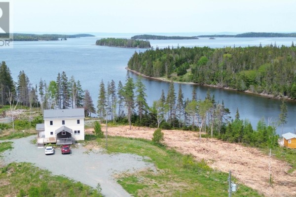 Aerial view of a house on a waterfront property with a lake and surrounding trees. - 1589 Corbetts Cove Road, Barra Head