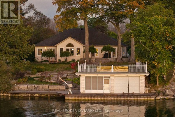 Rear view of a house with a boathouse and dock on the water's edge. - 159 Creighton Street, Ramara