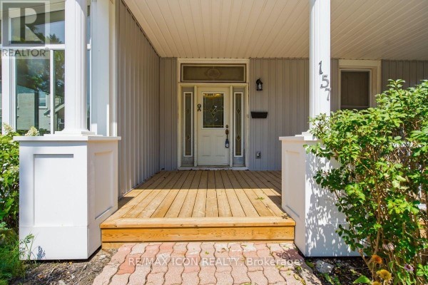 Close-up of the front porch entrance with a wooden deck and white columns. - 159 Front Street W, Strathroy Caradoc