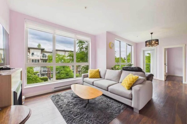 Living room with a large window showcasing a tree-lined street view and beige walls. - 15918 26 Avenue, Surrey
