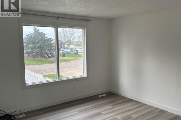 Bedroom with a large window overlooking the street and a white ceiling. - 15b Erixon Place, Clavet