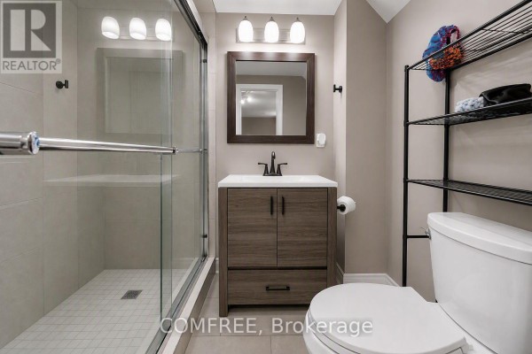 Detailed view of a brick townhouse exterior featuring a stone archway above the front door. - 15d View Green Crescent, Toronto