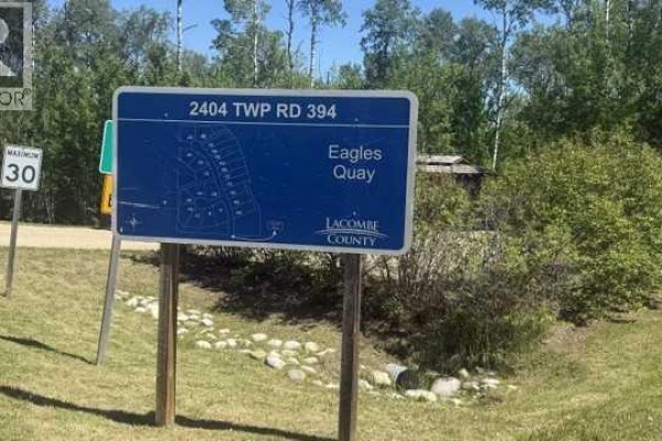 A blue sign displays a map of Eagles Quay and Lacombe County road information. - 16, 2404 394 Township, Rural Lacombe County