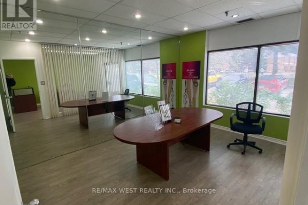 Commercial office space with large mirrored wall, two oval desks, and vertical blinds. - 16 - 500 Alden Road, Markham
