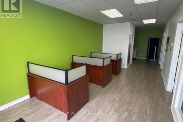 Hallway with a reception desk area featuring three wooden counters with frosted glass panels. - 16 - 500 Alden Road, Markham