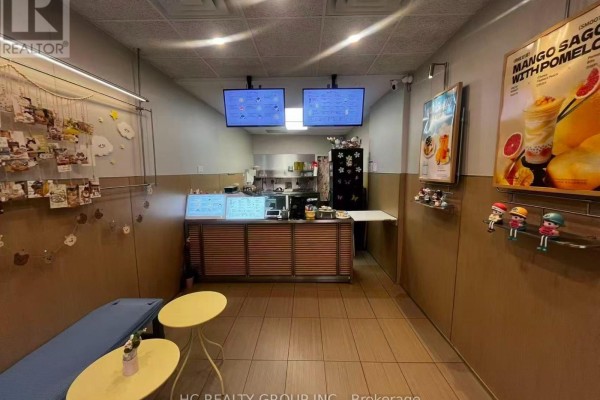 View of the commercial space interior, including seating, counter, and kitchen area. - 16 - 5418 Yonge Street, Toronto
