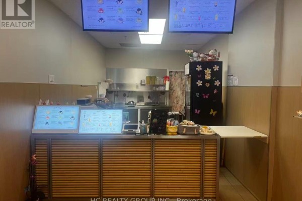 Close-up of the service counter with digital menu screens and point-of-sale equipment. - 16 - 5418 Yonge Street, Toronto