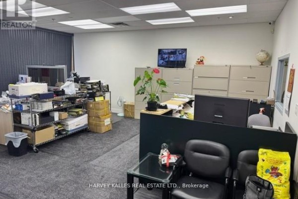Office area with desks, filing cabinets, shelving, chairs, and a monitor showing security cameras. - 16 - 60 West Wilmot Street, Richmond Hill