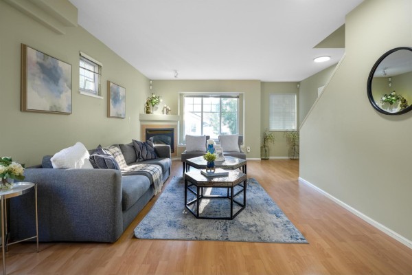Kitchen with white cabinets, a refrigerator, and a dining area with a wooden table and chairs. - 16 12110 75a Avenue, Surrey