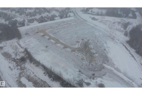 Overhead view of land with snow, showcasing planned roadways and surrounding trees. - 16 26131 Twp Rd 532a, Rural Parkland County