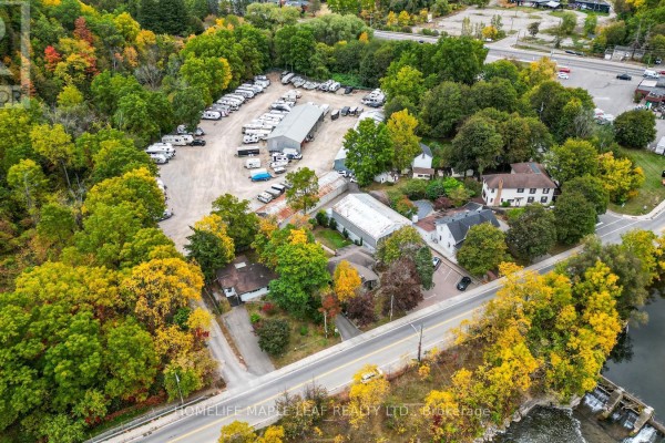 Overhead view of 16 Adamson Street property, showing buildings, RVs, and surrounding trees in autumn colors. - 16 Adamson Street, Halton Hills