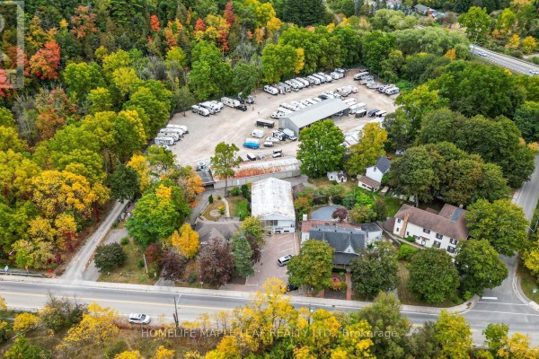 Drone shot of 16 Adamson Street's commercial buildings and paved lot filled with RVs and vehicles. - 16 Adamson Street, Halton Hills