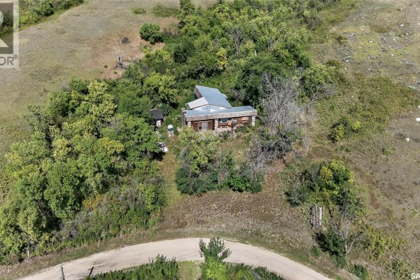 Drone shot of a secluded house situated on a wooded slope with clear skies. - 16 Alice Crescent, North Grove