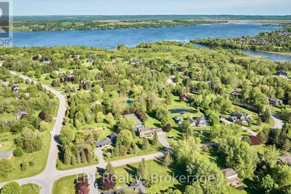Backyard swimming pool with a slide, surrounded by a fence and green lawn. - 16 Cawkers Cove Road, Scugog