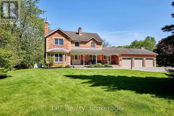 View of the fenced swimming pool, green grass, and trees under a blue sky. - 16 Cawkers Cove Road, Scugog