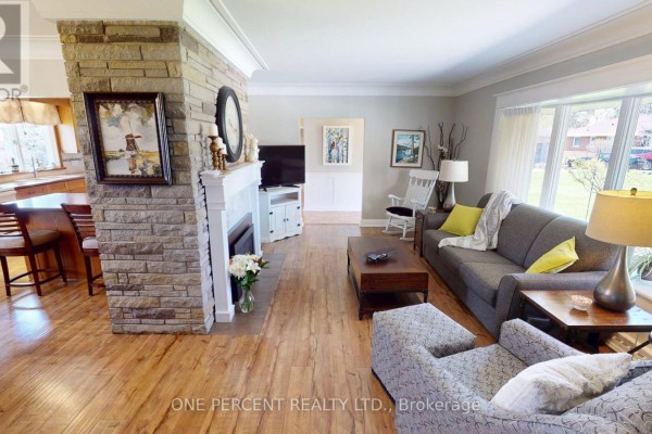 Kitchen with dual sinks, oak cabinets, white dishwasher, and a large window overlooking the backyard. - 16 Daleview Crescent, Pelham