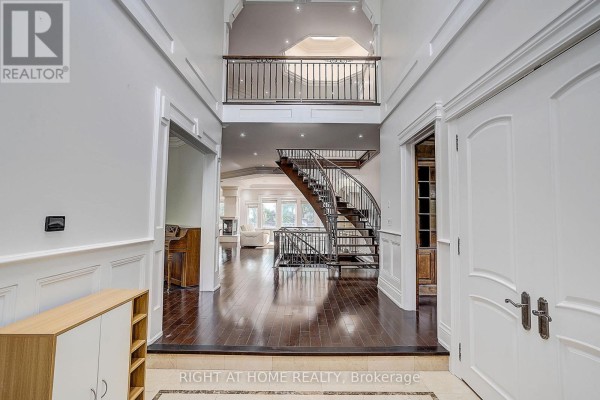 Grand entryway with curved staircase, hardwood floors, and high ceilings - 16 Fairview Avenue Richmond Hill