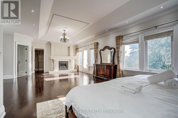 Bedroom with fireplace, walk-in closet, tray ceiling, and chandelier - 16 Fairview Avenue Richmond Hill