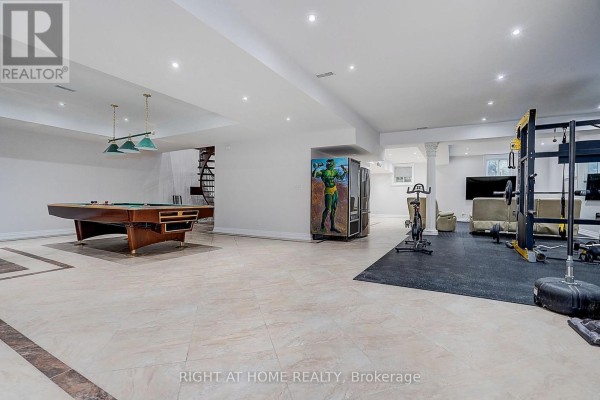 Finished basement with pool table, gym equipment, and seating - 16 Fairview Avenue Richmond Hill